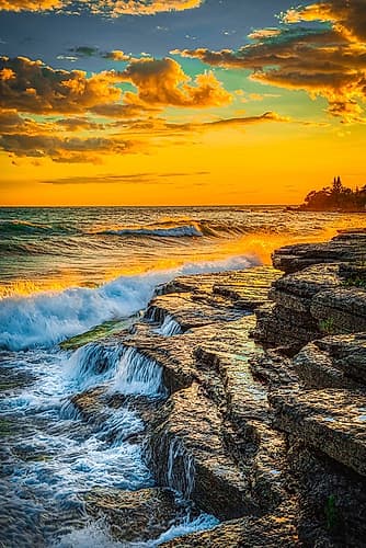 USA-New York-Lake Ontario Sunset waves on rocky shoreline Coastal Print